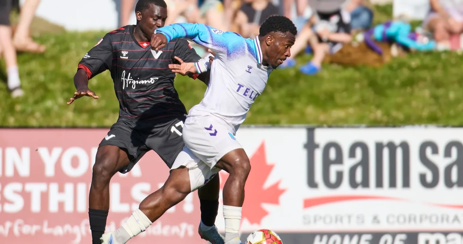 Player from Pacific FC dribbling past defender Player from Pacific FC dribbling past defender