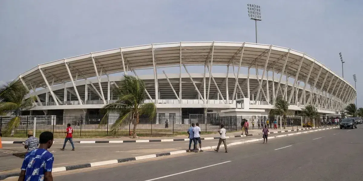 Exterior view of stadium with pedestrians and vehicles Exterior view of stadium with pedestrians and vehicles