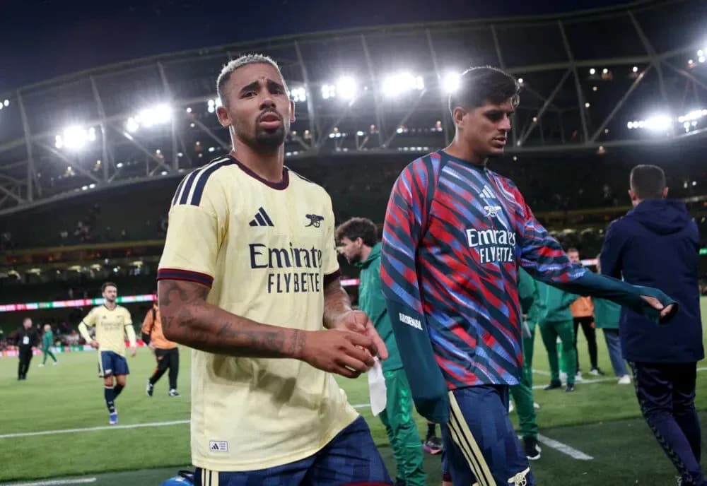 Two Arsenal players walking off the pitch after match Two Arsenal players walking off the pitch after match