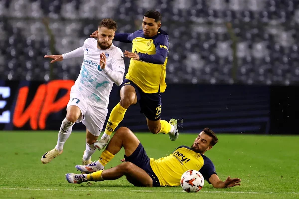 Player evading tackle during intense football match Player evading tackle during intense football match