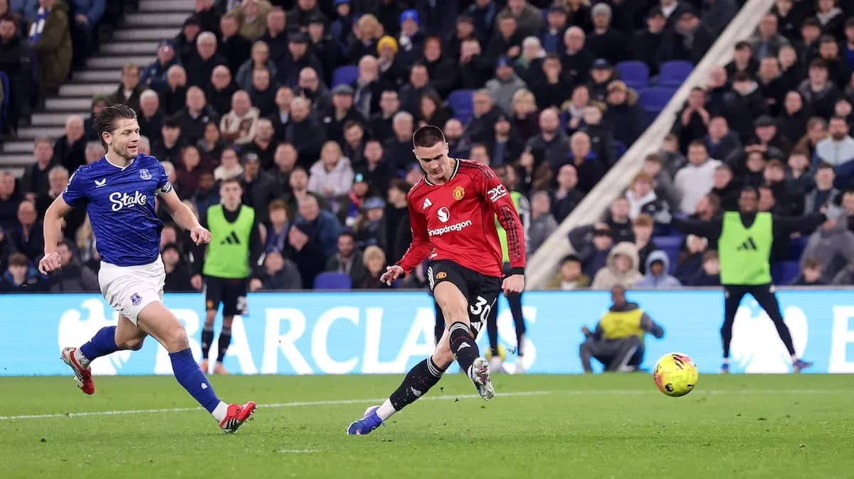 Everton player challenging Manchester United forward Everton player challenging Manchester United forward