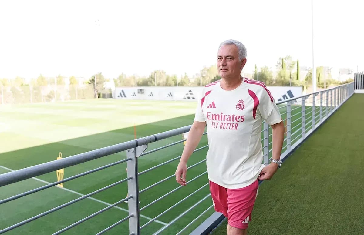 Coach walking on training pitch at facility Coach walking on training pitch at facility