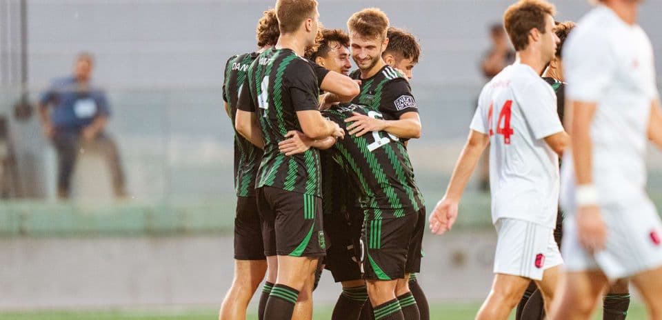 Players celebrating a goal during match Players celebrating a goal during match