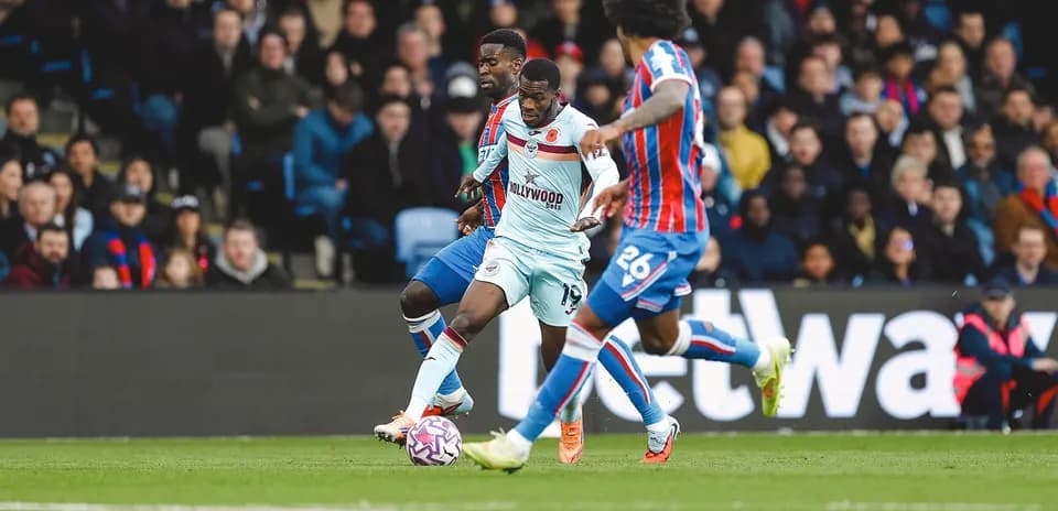 Brentford player dribbling past Crystal Palace defenders Brentford player dribbling past Crystal Palace defenders