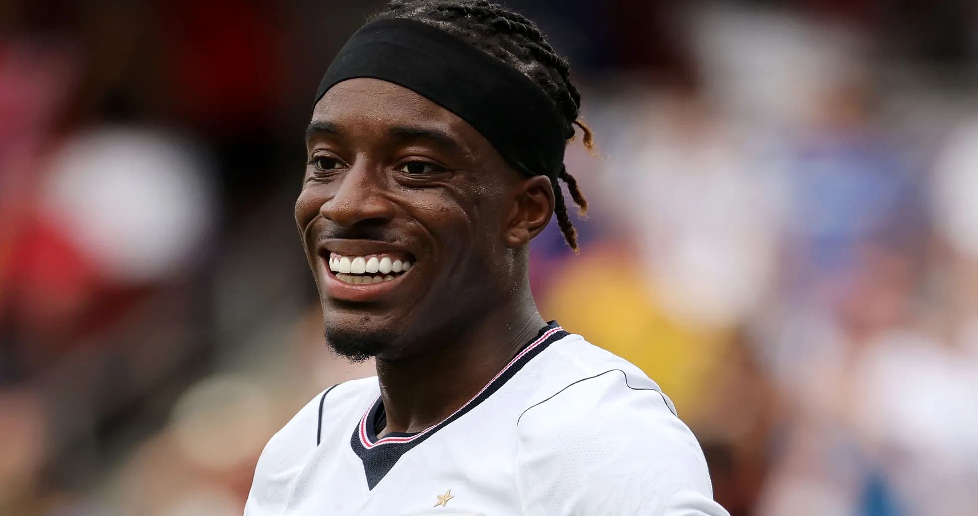 Soccer player smiling during match warm-up Soccer player smiling during match warm-up