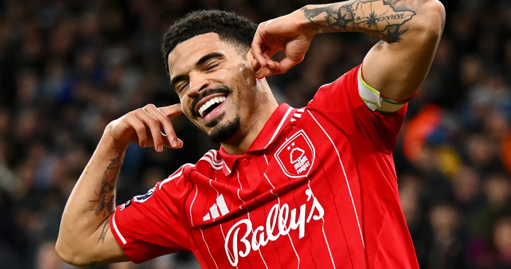 Player celebrating in red jersey after scoring Player celebrating in red jersey after scoring