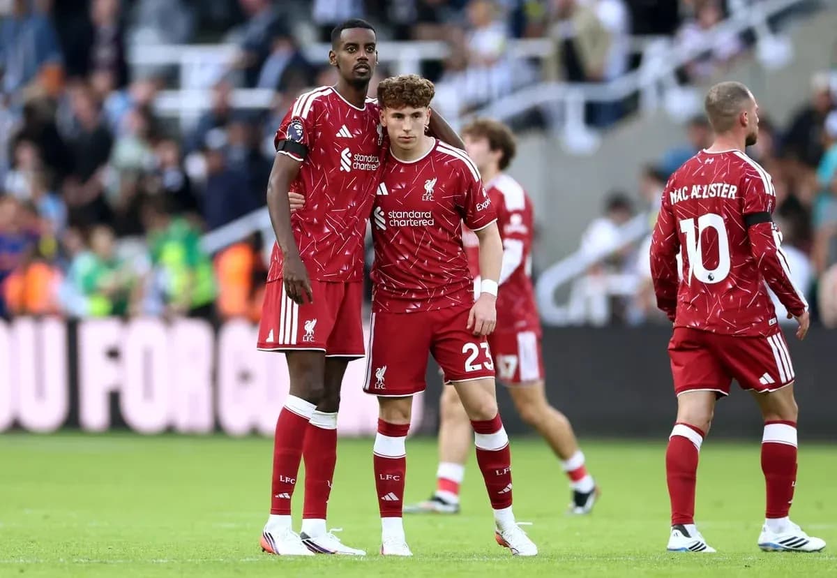 Two Liverpool players discussing on the pitch Two Liverpool players discussing on the pitch