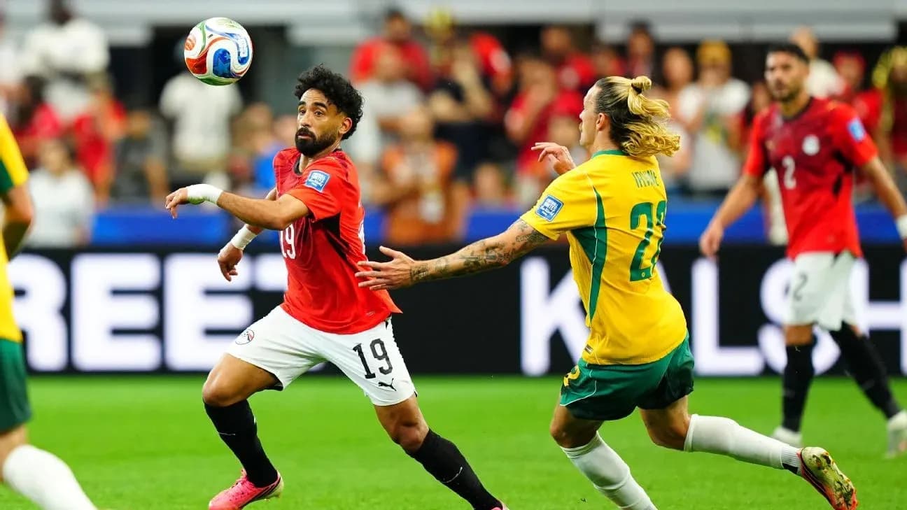 Player from Egypt and Australia competing for the ball Player from Egypt and Australia competing for the ball