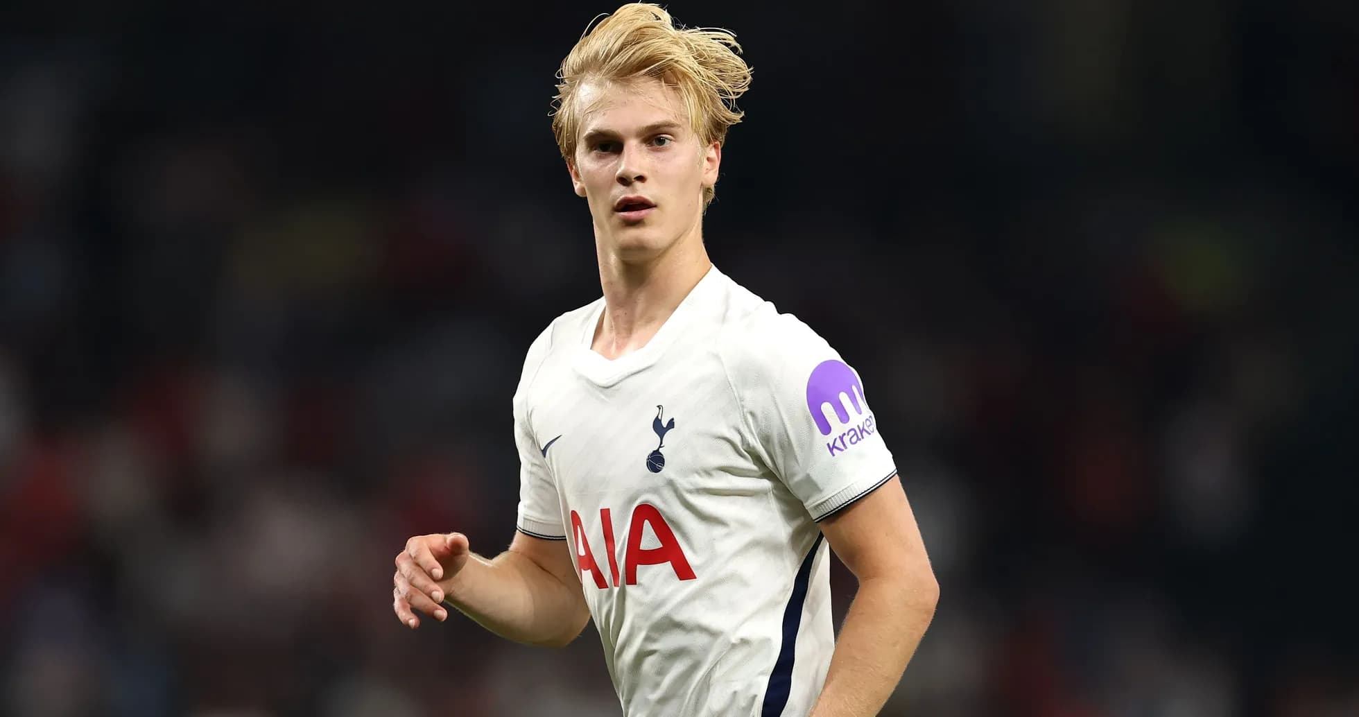 Player in Tottenham jersey running on the pitch Player in Tottenham jersey running on the pitch