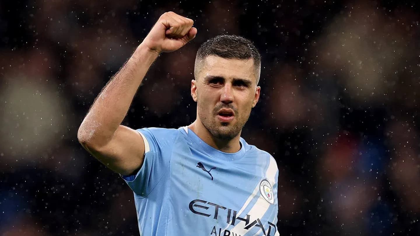 Player celebrating with raised fist in Manchester City jersey Player celebrating with raised fist in Manchester City jersey