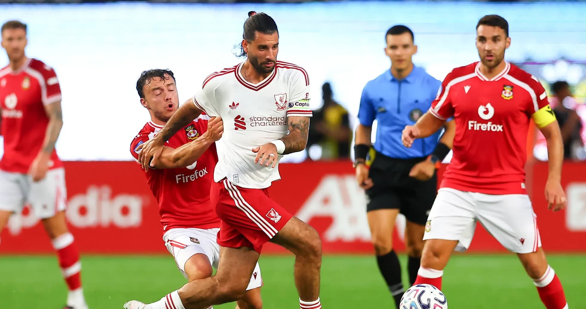 Player in white dribbling past opponent in red jersey Player in white dribbling past opponent in red jersey