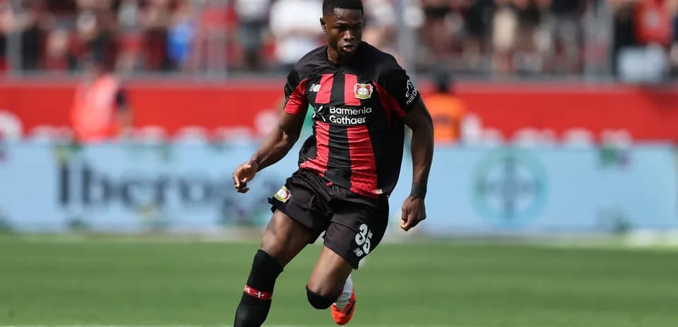 Player in Bayer Leverkusen kit dribbling the ball Player in Bayer Leverkusen kit dribbling the ball