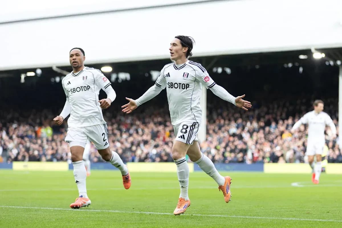 Fulham players celebrating a goal on the pitch Fulham players celebrating a goal on the pitch