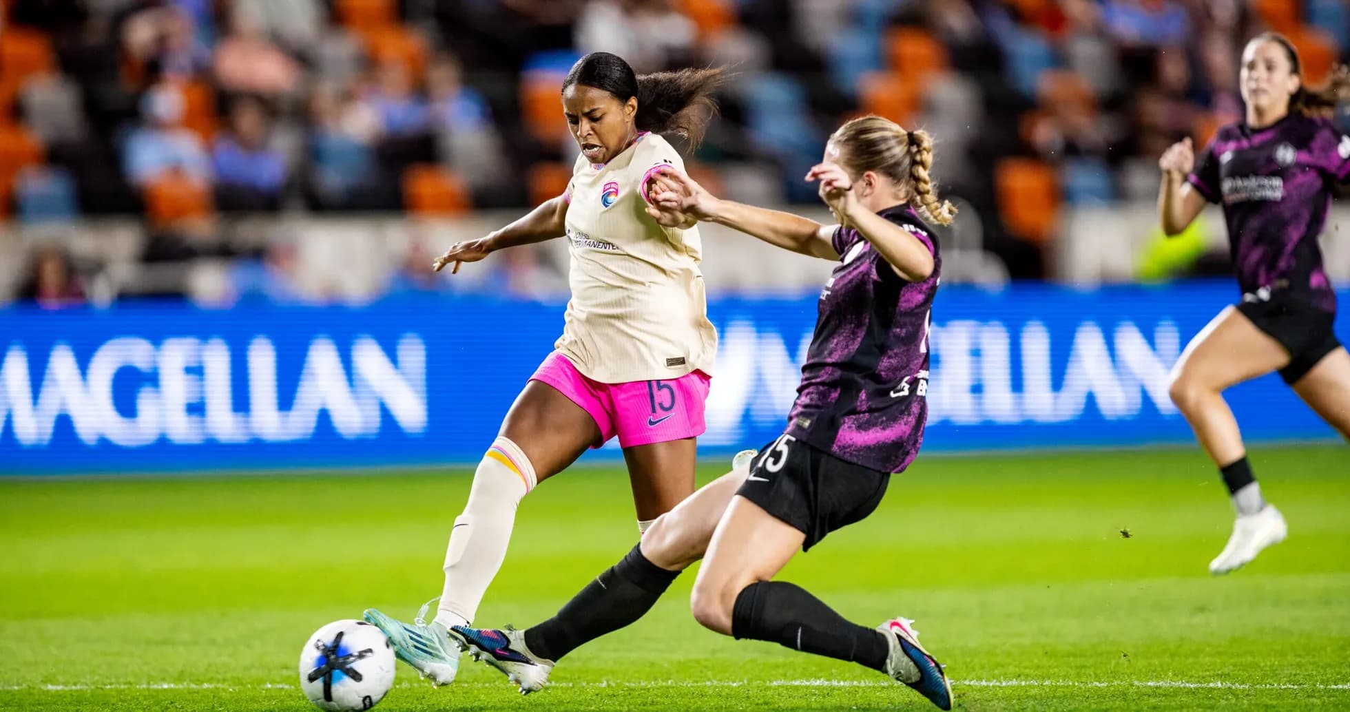 Player tackling opponent during NWSL match Player tackling opponent during NWSL match