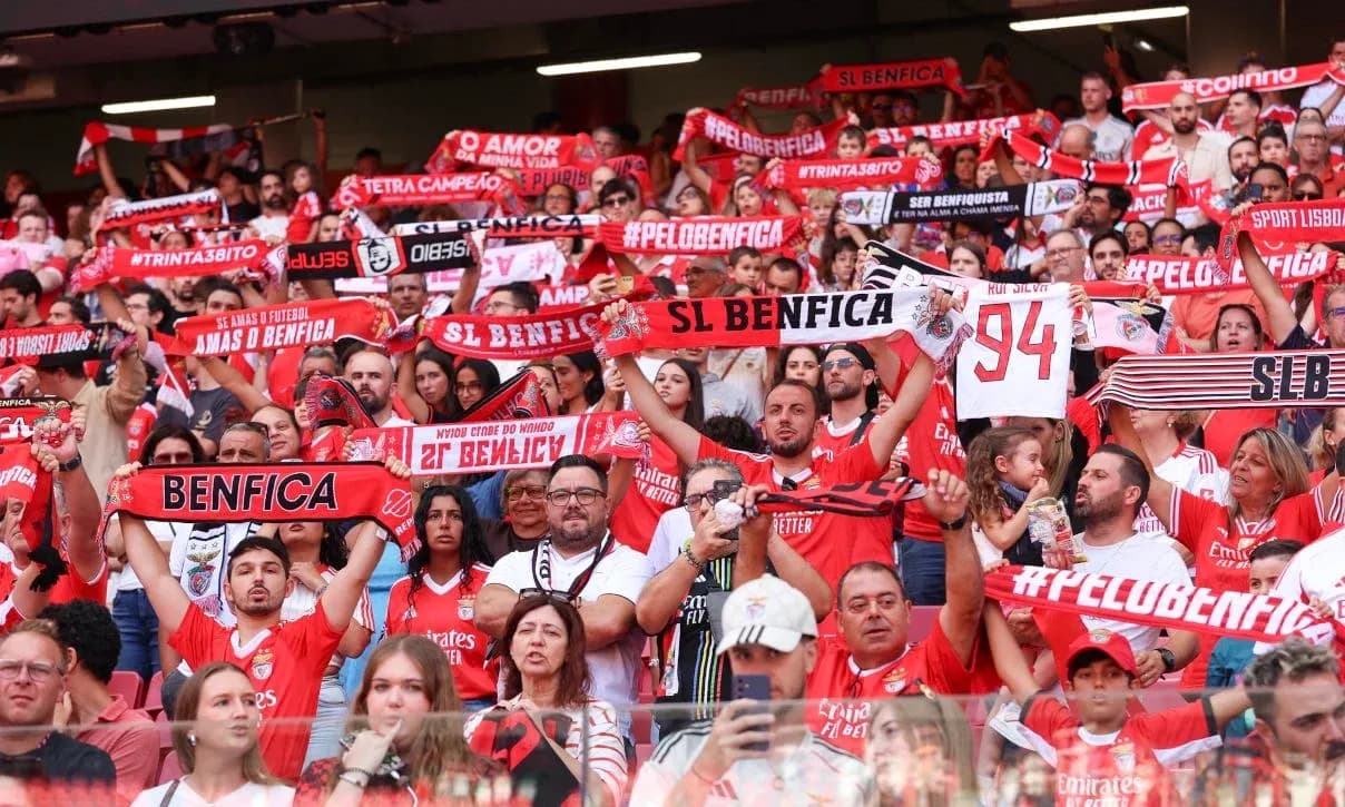 Benfica fans cheering with scarves in stadium Benfica fans cheering with scarves in stadium