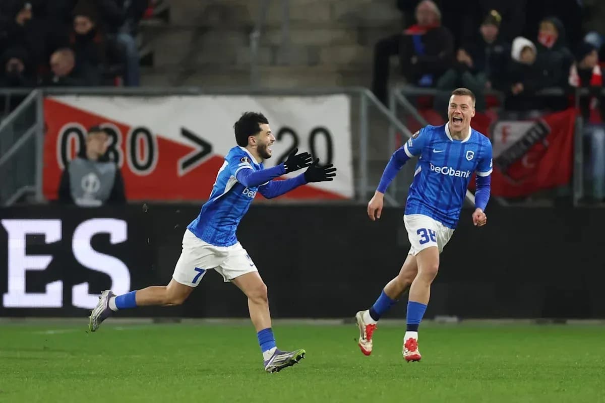 Two players celebrating a goal on the field Two players celebrating a goal on the field