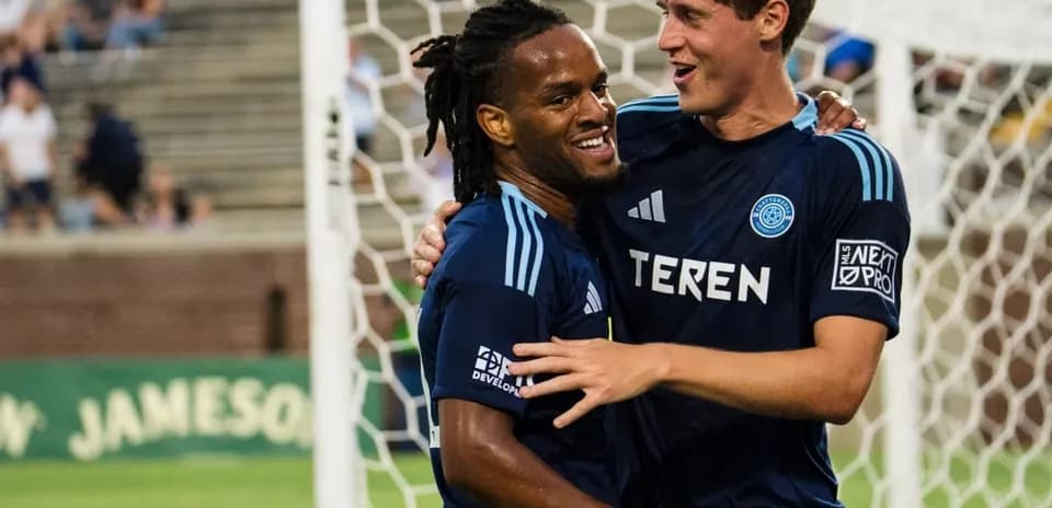 Two players celebrating a goal during match Two players celebrating a goal during match