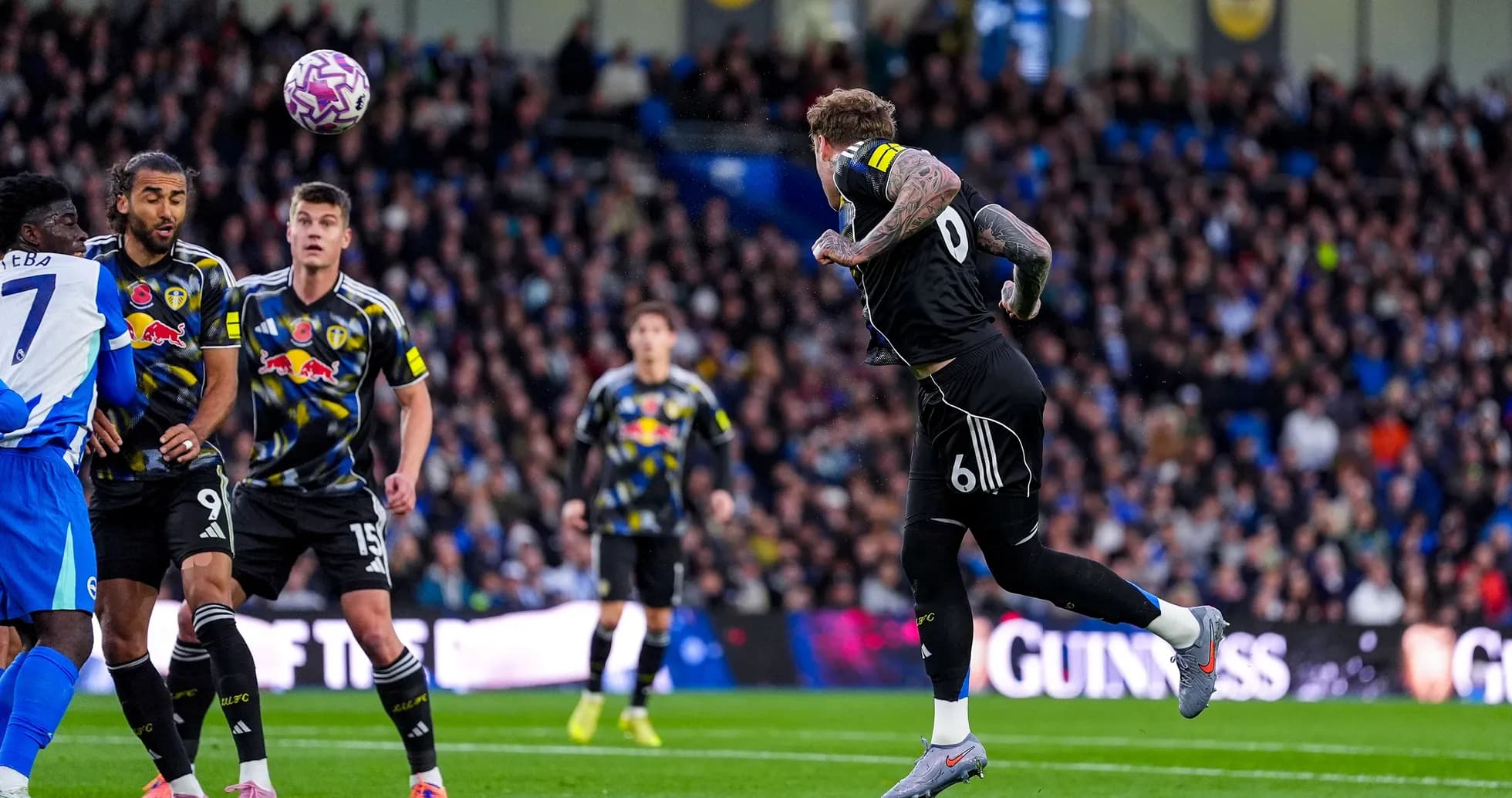 Leeds player heading the ball in match Leeds player heading the ball in match