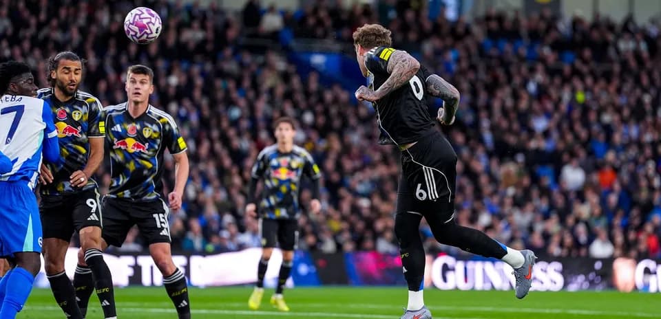 Leeds player heading the ball in match Leeds player heading the ball in match
