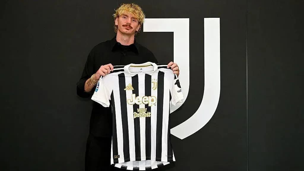 Player holding Juventus jersey in front of logo Player holding Juventus jersey in front of logo