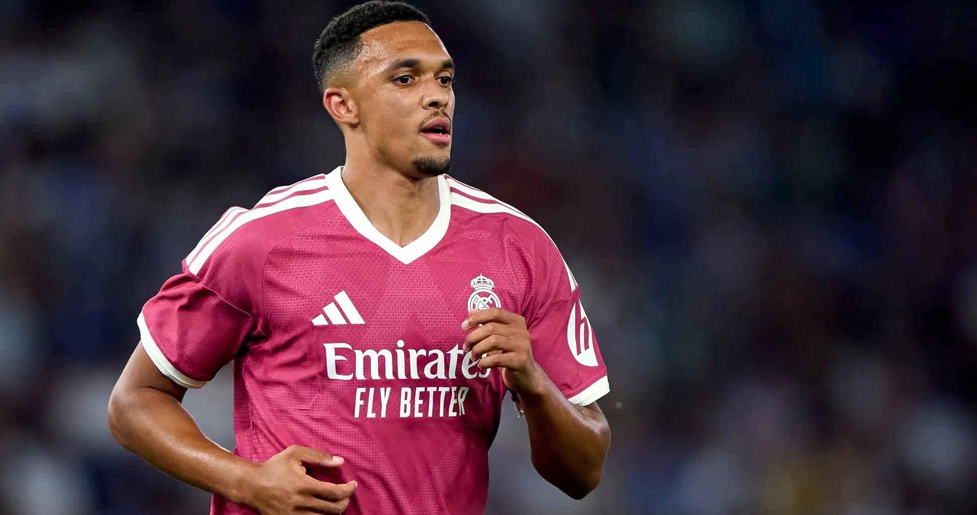 Player running in pink Real Madrid jersey during match Player running in pink Real Madrid jersey during match