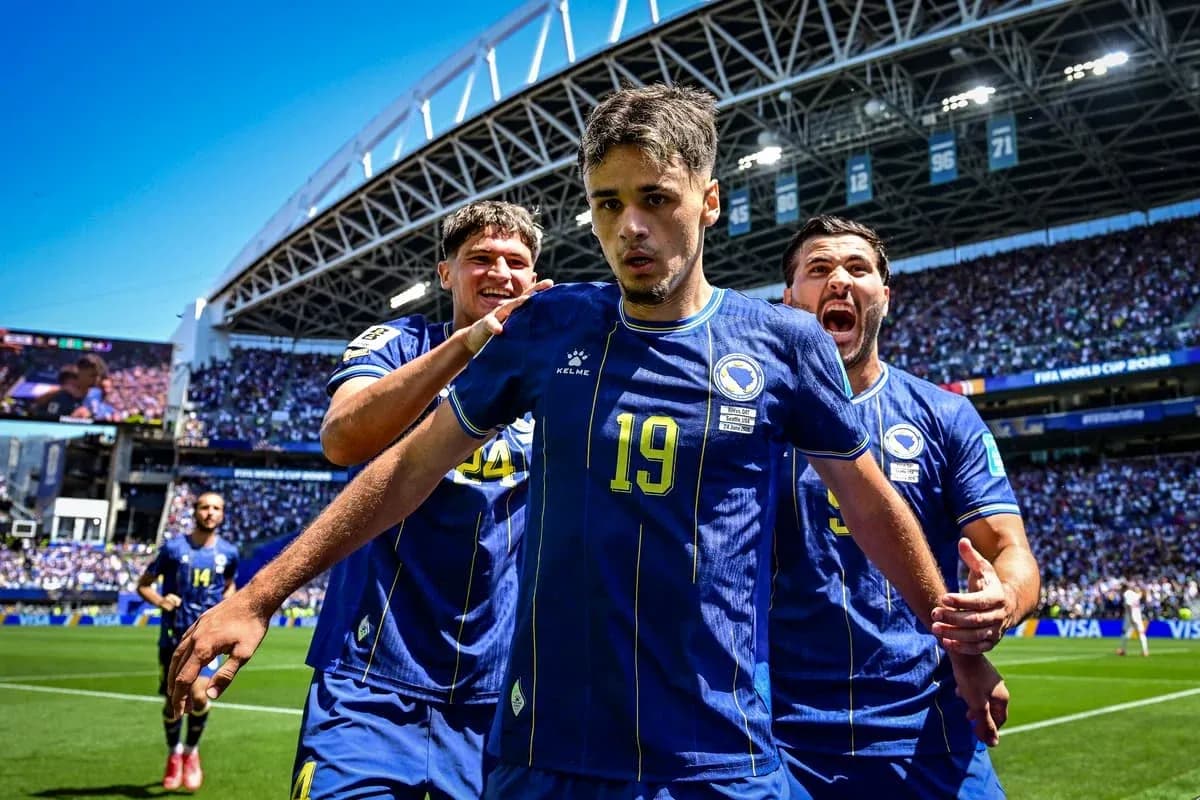 Bosnia players celebrating a goal on the field Bosnia players celebrating a goal on the field