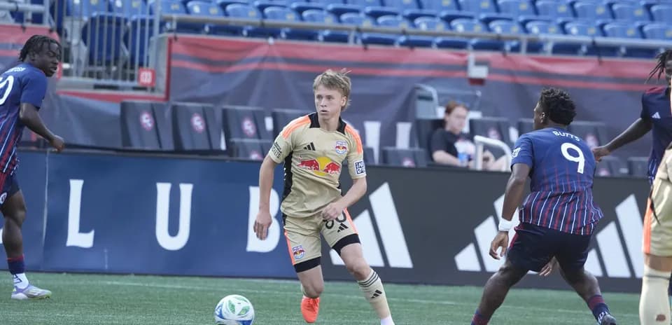 New York RB II player dribbling ball against opponents New York RB II player dribbling ball against opponents