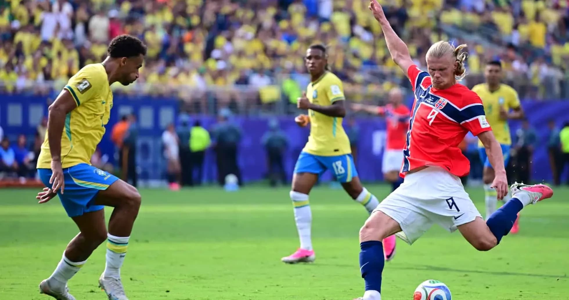 Player from Brazil and Norway competing for the ball Player from Brazil and Norway competing for the ball